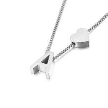 Cargar imagen en el visor de la galería, Un collar de plata con un atrevido dije de una "A" mayúscula y un dije de corazón en una delicada cadena de caja, perfecto para combinar con el plateado Pulsera de tobillo con inicial para un look coordinado.