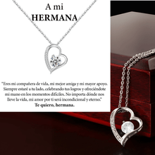 Cargar imagen en el visor de la galería, El collar Amor eterno es un collar de plata de acero inoxidable en forma de corazón con un colgante de cristal, bellamente presentado en un joyero. El mensaje en español expresa amor eterno-un regalo ideal para mujer y perfecto para una hermana querida.