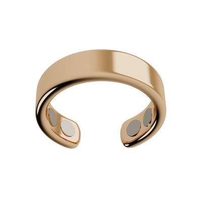 El Anillo de Magnoterapia - Alivio para la menopausia, en color dorado, presenta un diseño abierto y pulido con dos pequeños círculos metálicos en los extremos internos, expuesto sobre fondo blanco.