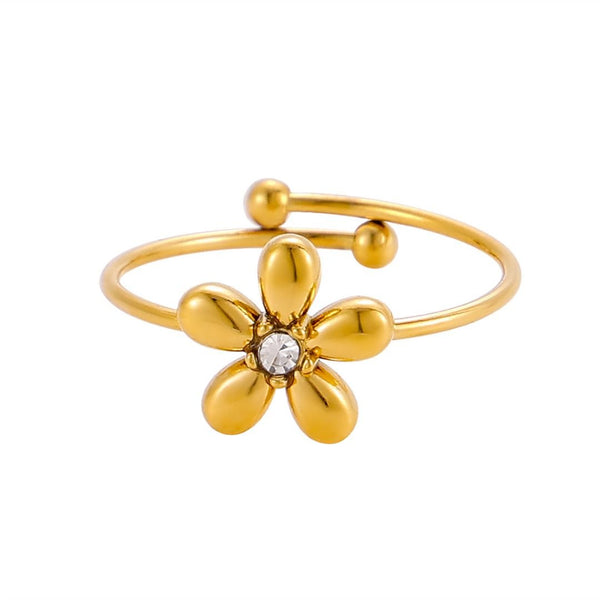 El Anillo Flor ajustable es un delicado anillo con una banda abierta de oro, cinco pétalos redondeados, una gema central transparente y dos pequeñas esferas de oro en los extremos para añadir encanto.