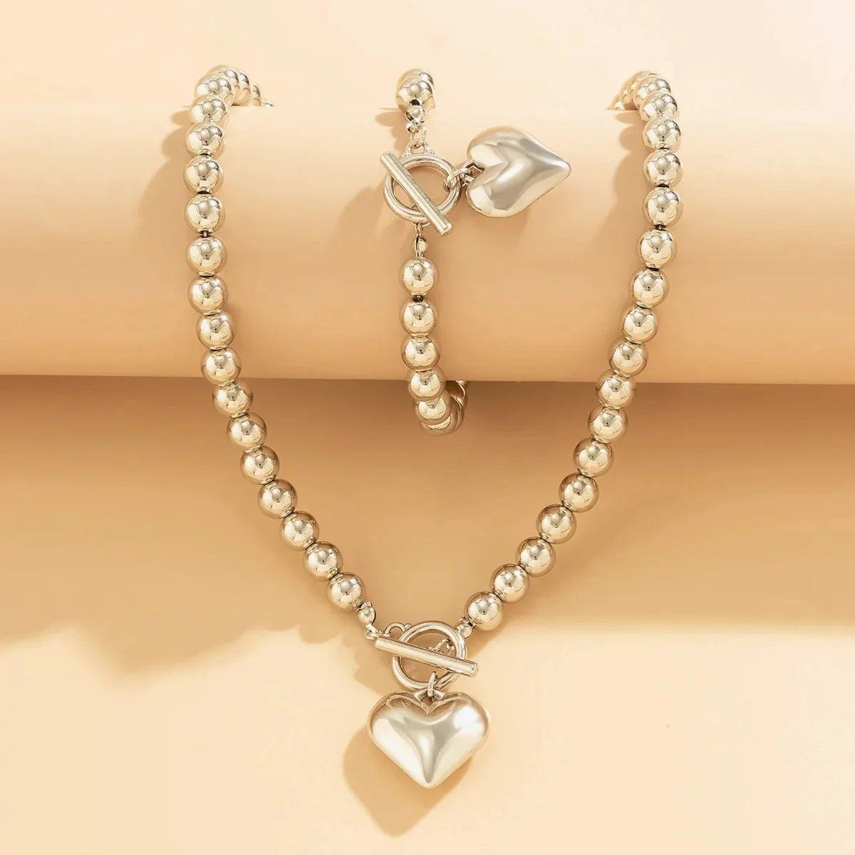 Conjunto de pulsera y collar con colgante de corazón de perlas