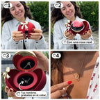 Una mujer recibe una Caja Corazón con rosa eterna y collar corazón personalizado; sonríe, se pone el collar grabado y lo señala con orgullo.