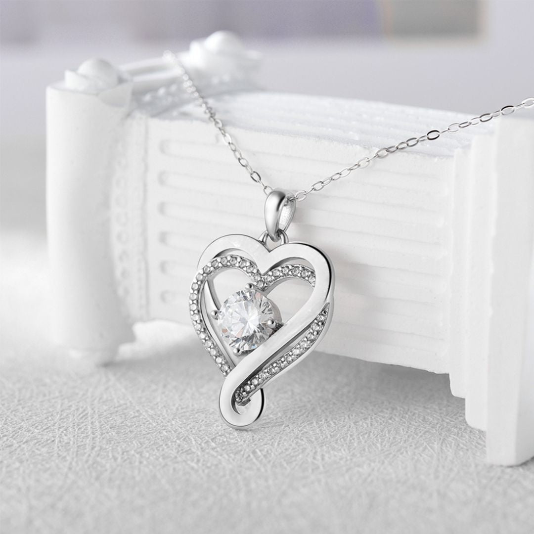 El Collar "A mi Esposa" es un elegante colgante en forma de corazón con gema central y cristales, en cadena delicada de acero inoxidable. Ideal como regalo para parejas y ocasiones especiales.