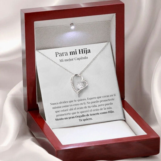 El collar Amor eterno - Para mi hija, un collar de acero inoxidable plateado en forma de corazón con un cristal, se presenta en un joyero rojo abierto. En el interior de la tapa aparece "Para mi Hija", un regalo ideal para demostrar su amor y orgullo.