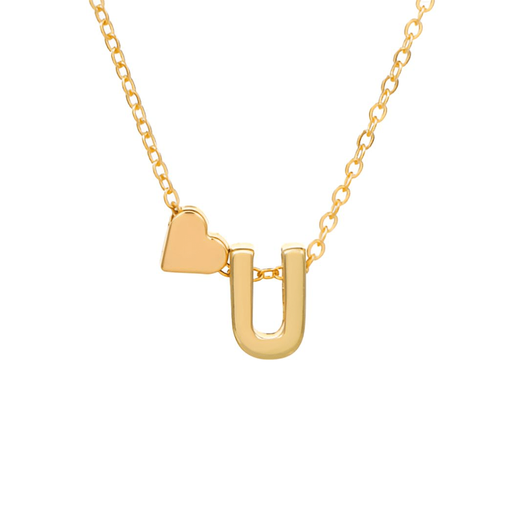 El Collar con inicial y corazón es un collar de oro con un colgante en forma de corazón junto a una letra en una delicada cadena -ambos colgantes en oro pulido- para un regalo personalizado y encantador.
