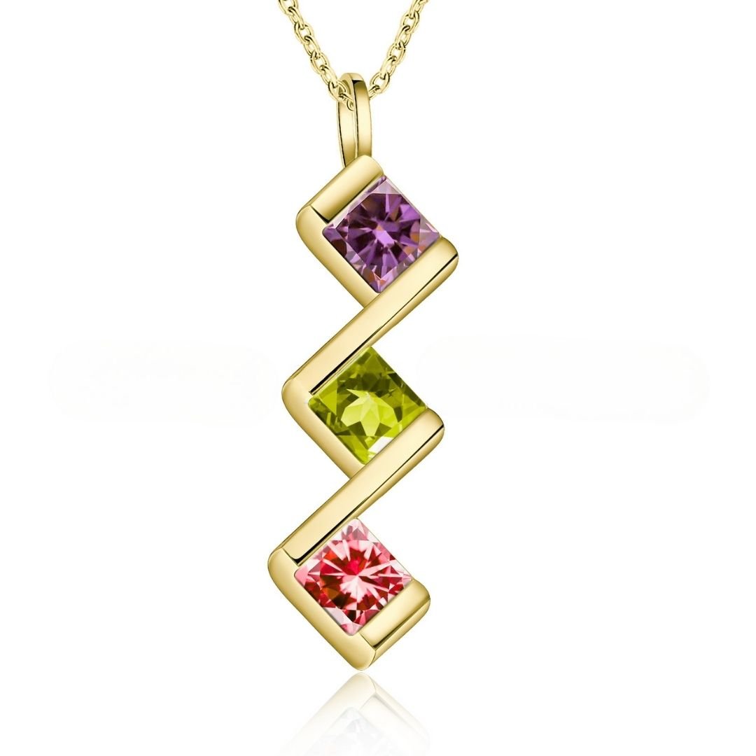 Collar con múltiples piedras de nacimiento: colgante dorado con diseño en zigzag y tres gemas (morada arriba, verde al centro, rosa abajo). Es el regalo perfecto para mamá.