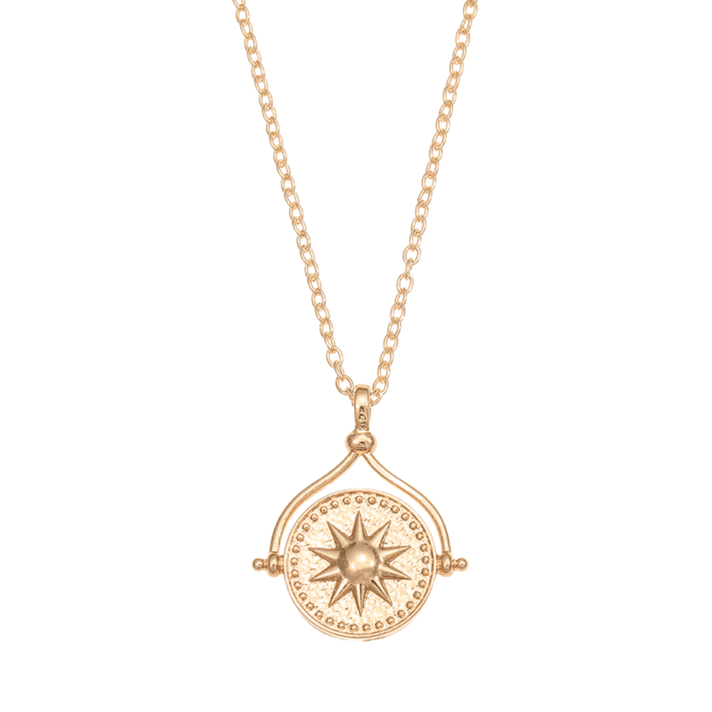 Collar giratorio Sol y Luna "Hatha": un collar dorado con dije circular giratorio, diseño central de sol en relieve y detalles de pequeños puntos en el borde, colgando de una cadena delicada.
