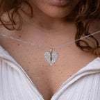 Persona que lleva un top de canalé color crema con cremallera parcialmente abierta, luciendo el collar personalizado "Mi ángel guardián" (Oferta 2X1) con un colgante de alas de ángel.