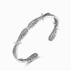 La Pulsera Alas de ángel es una pulsera brazalete de plata con detallados dibujos de alas de ángel, con un acabado pulido y abierto: un elegante y delicado regalo Abrazo del Cielo para sus seres queridos.