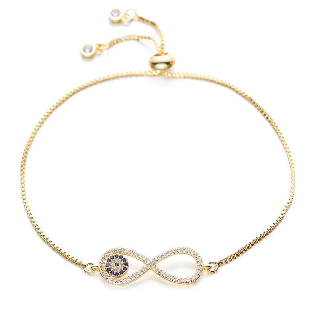 Pulsera Infinito con ojo turco (OFERTA 2X1): delicada pulsera dorada con símbolo infinito y piedras azules tipo "ojo turco" para protección, ajustable y terminada en cuentas perladas.