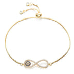 Pulsera Infinito con ojo turco (OFERTA 2X1): delicada pulsera dorada con símbolo infinito y piedras azules tipo "ojo turco" para protección, ajustable y terminada en cuentas perladas.
